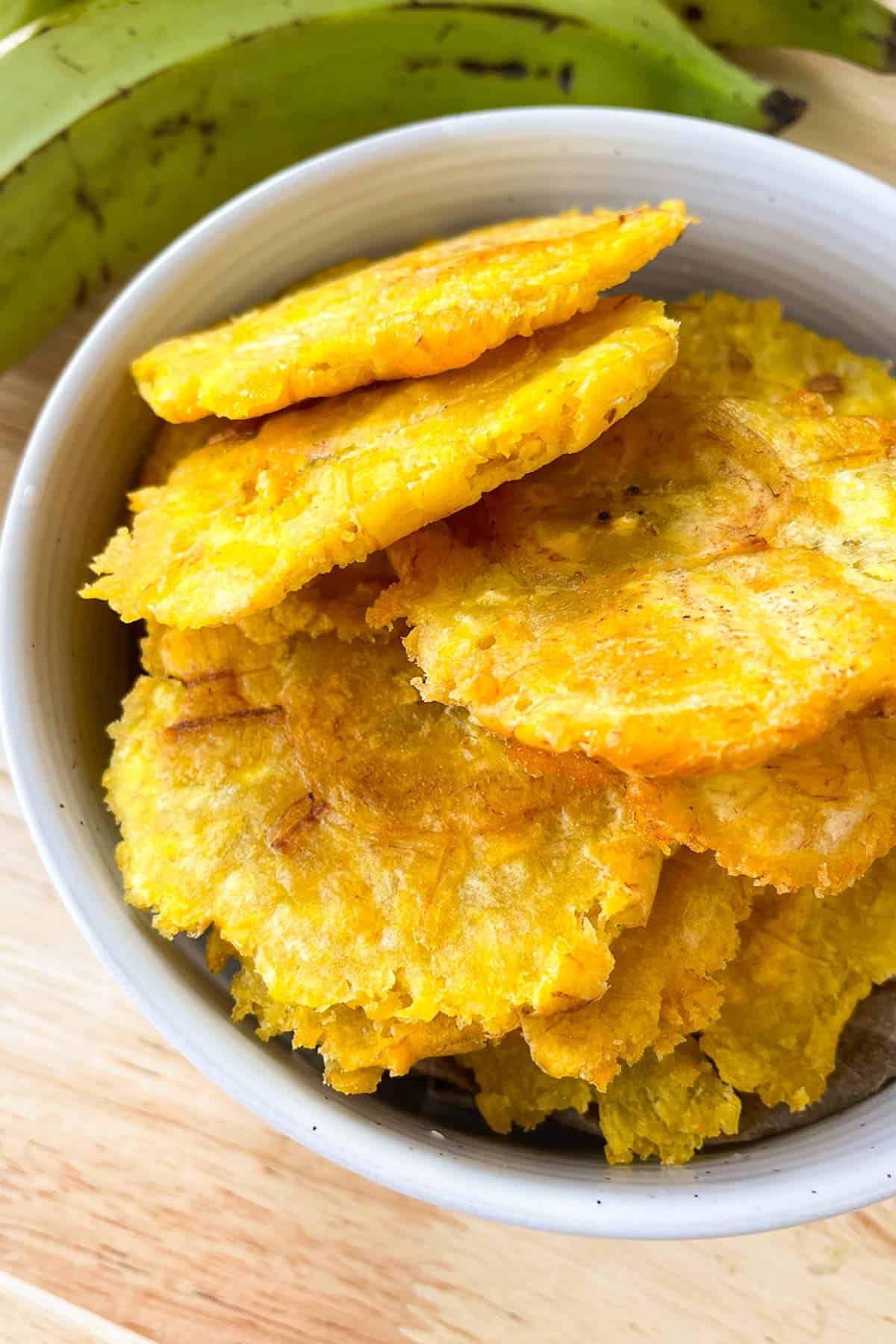 a big bowl full of fried green plantains.