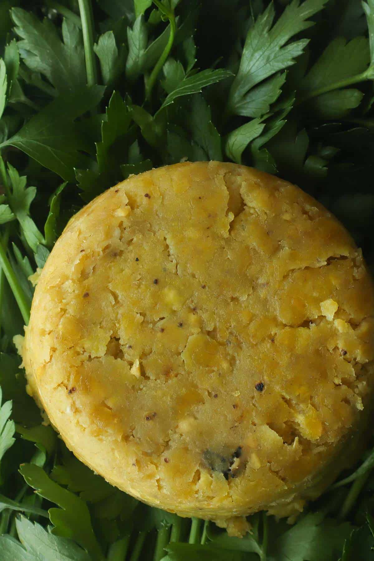 close up of a mofongo over a bed of parsley.