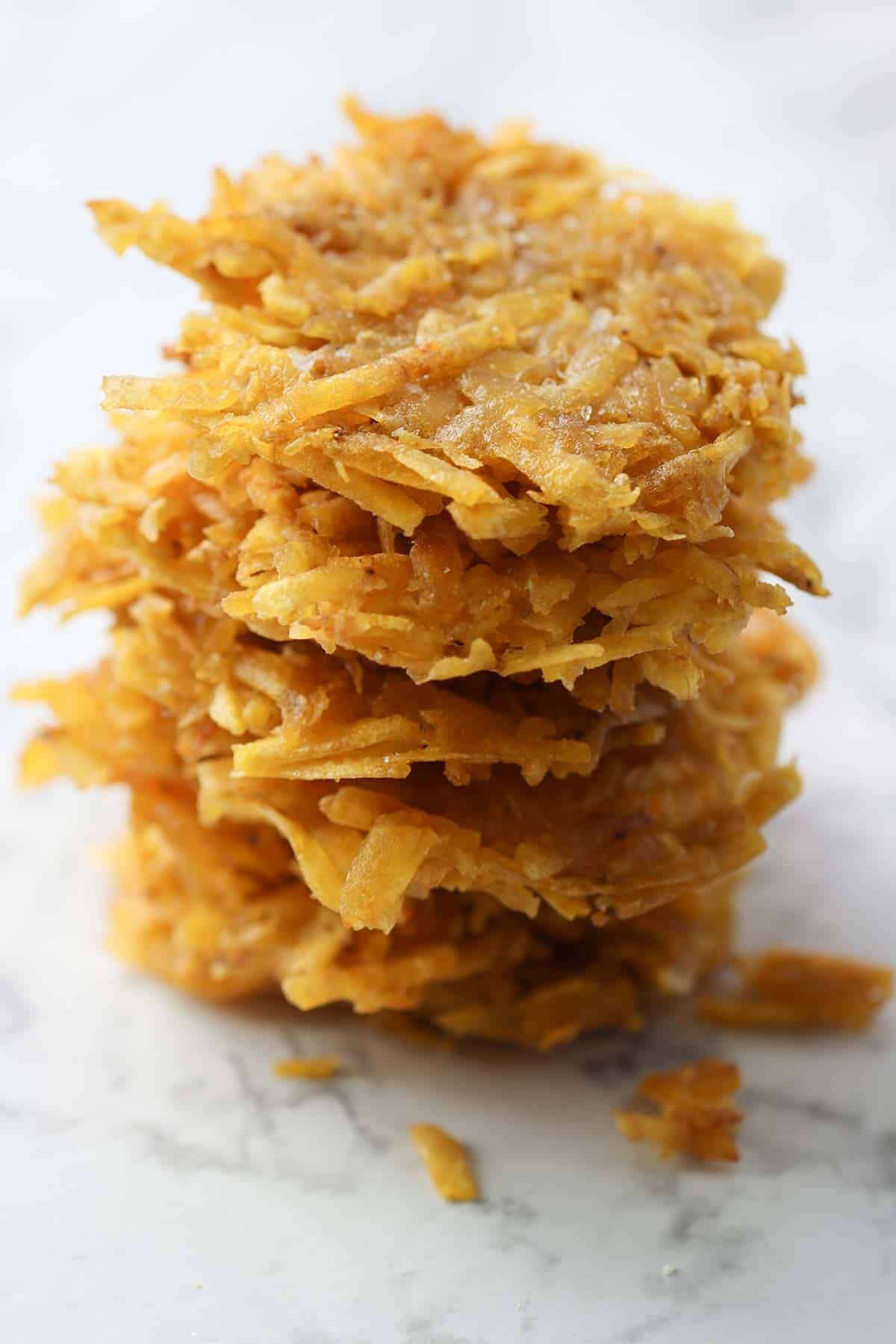 arranitas- shredded plantain patties in a stack.