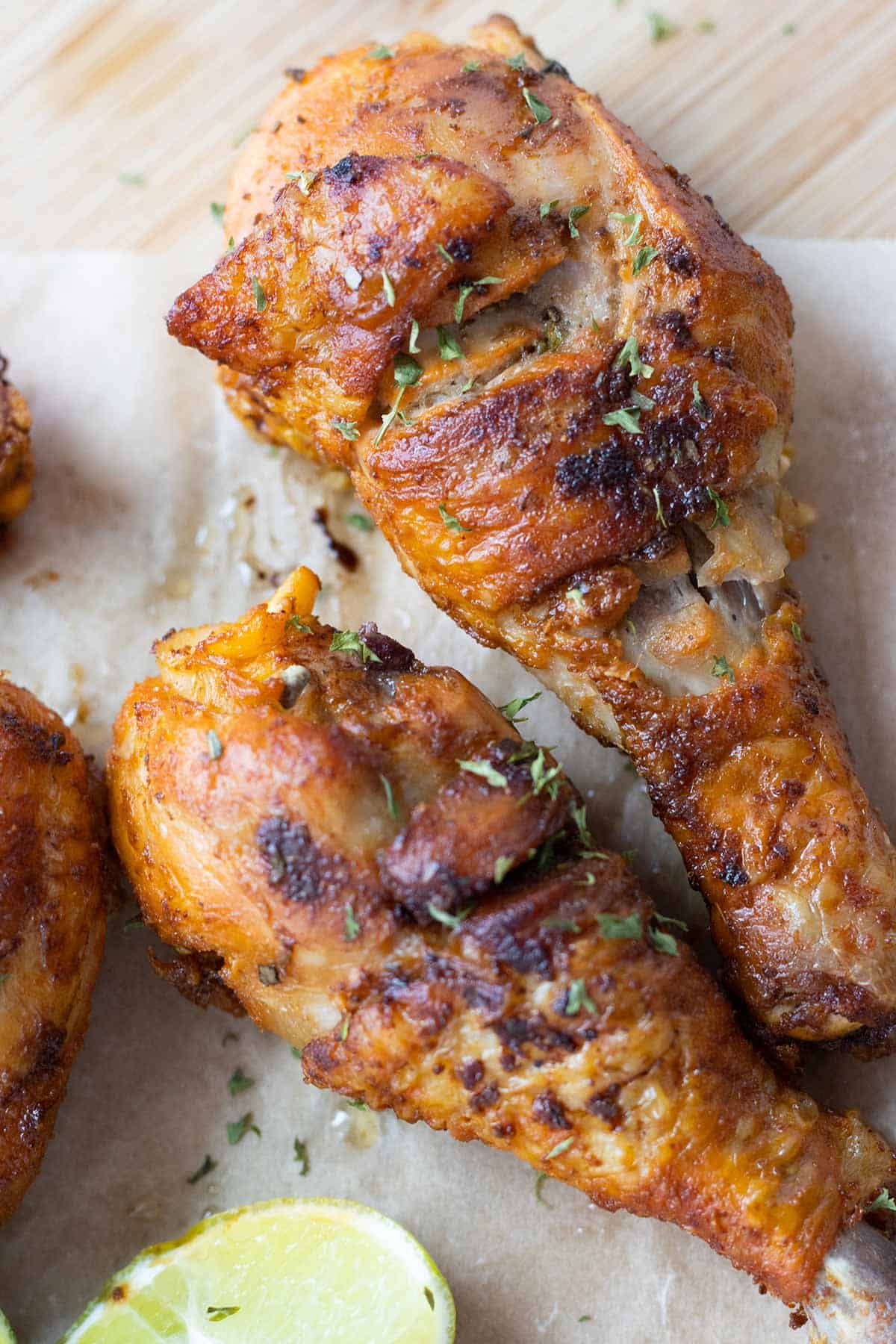 two pieces of fried chicken in the center with parts of chicken pieces showing on one side.