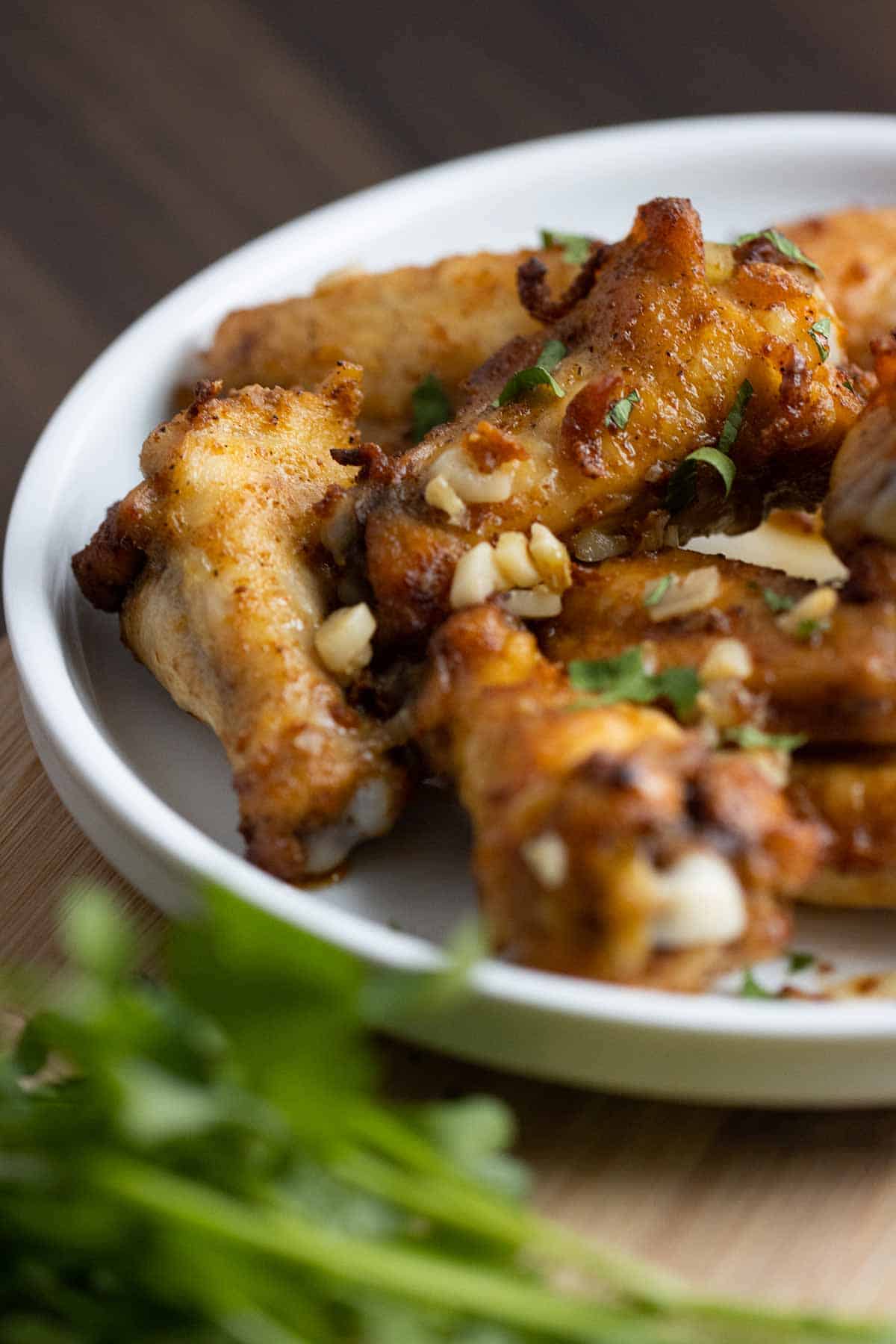 chicken wings with garlic and parsley on top.