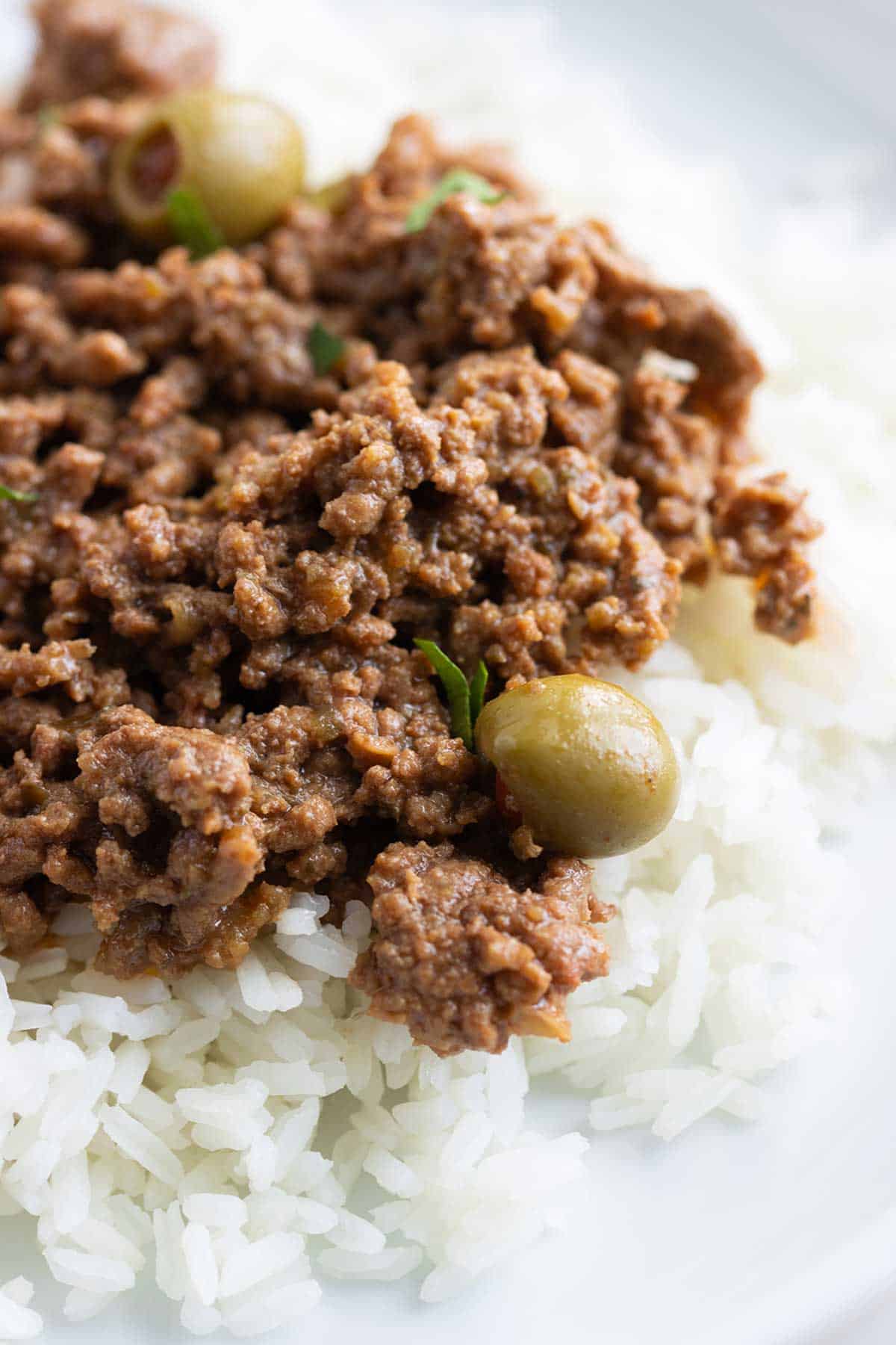 close up of puerto rican picadillo over white rice.