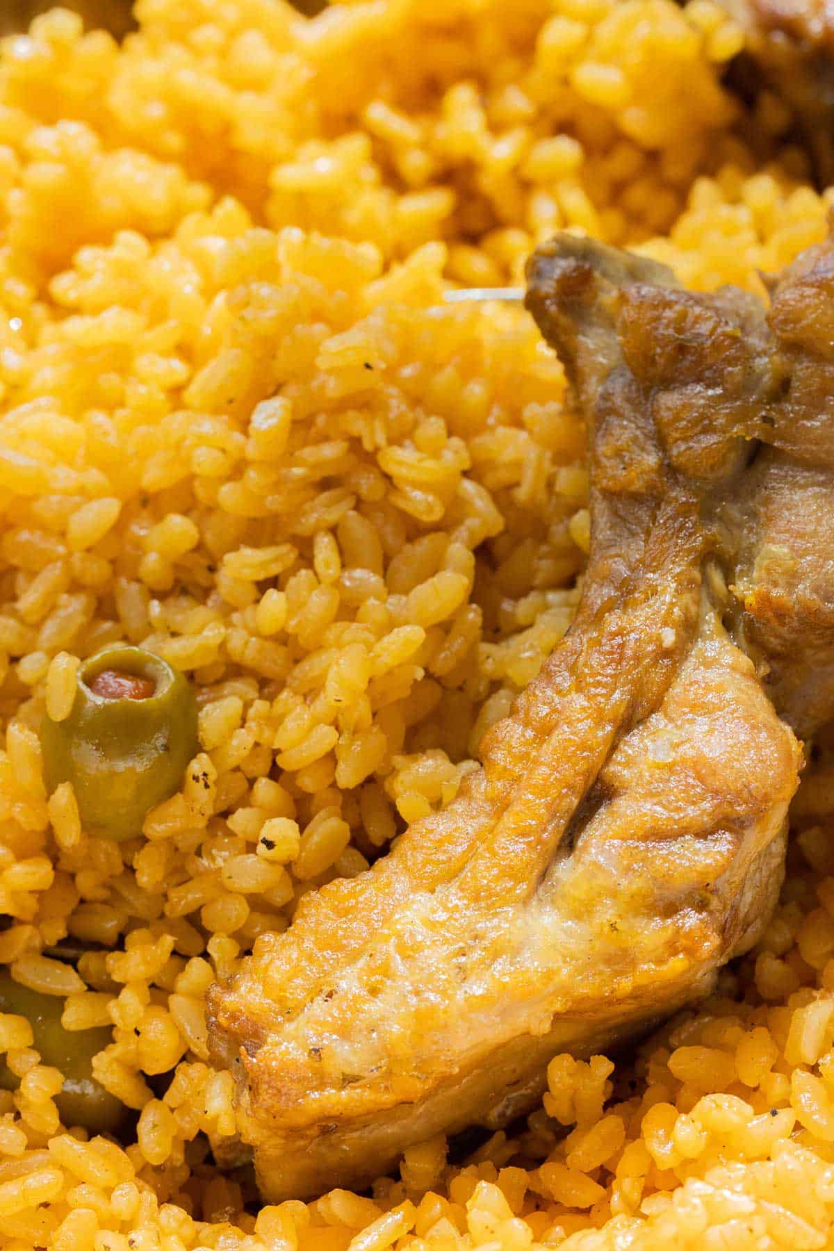 close up of a pork rib with rice with manzanilla olives.