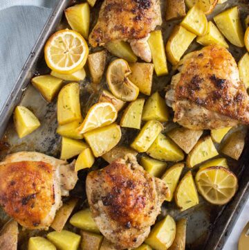 flat lay image of lemon chicken with potatoes in a tray.