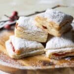 a wooden round plate with pastelillos de guayaba.