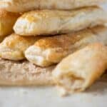 a piramid of quesitos with one on the side.