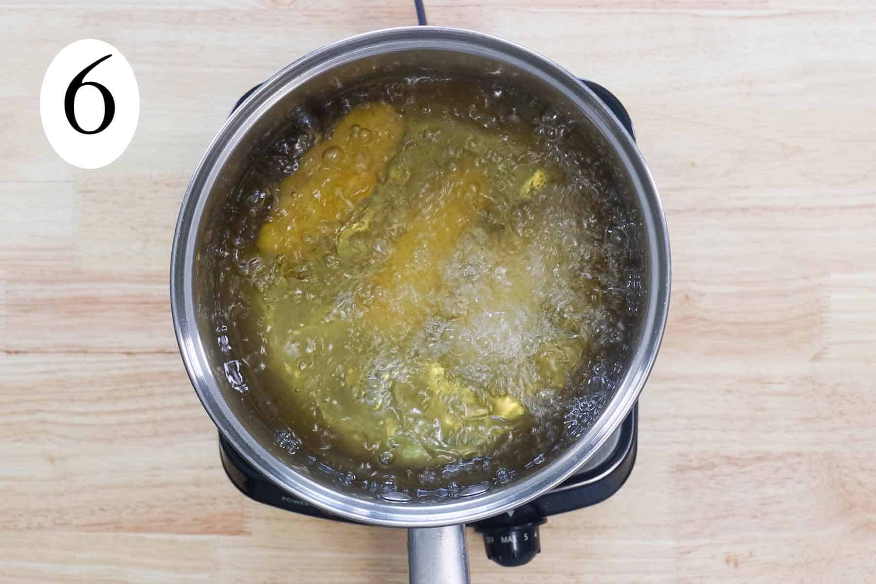 a big pot with frying sorullos.