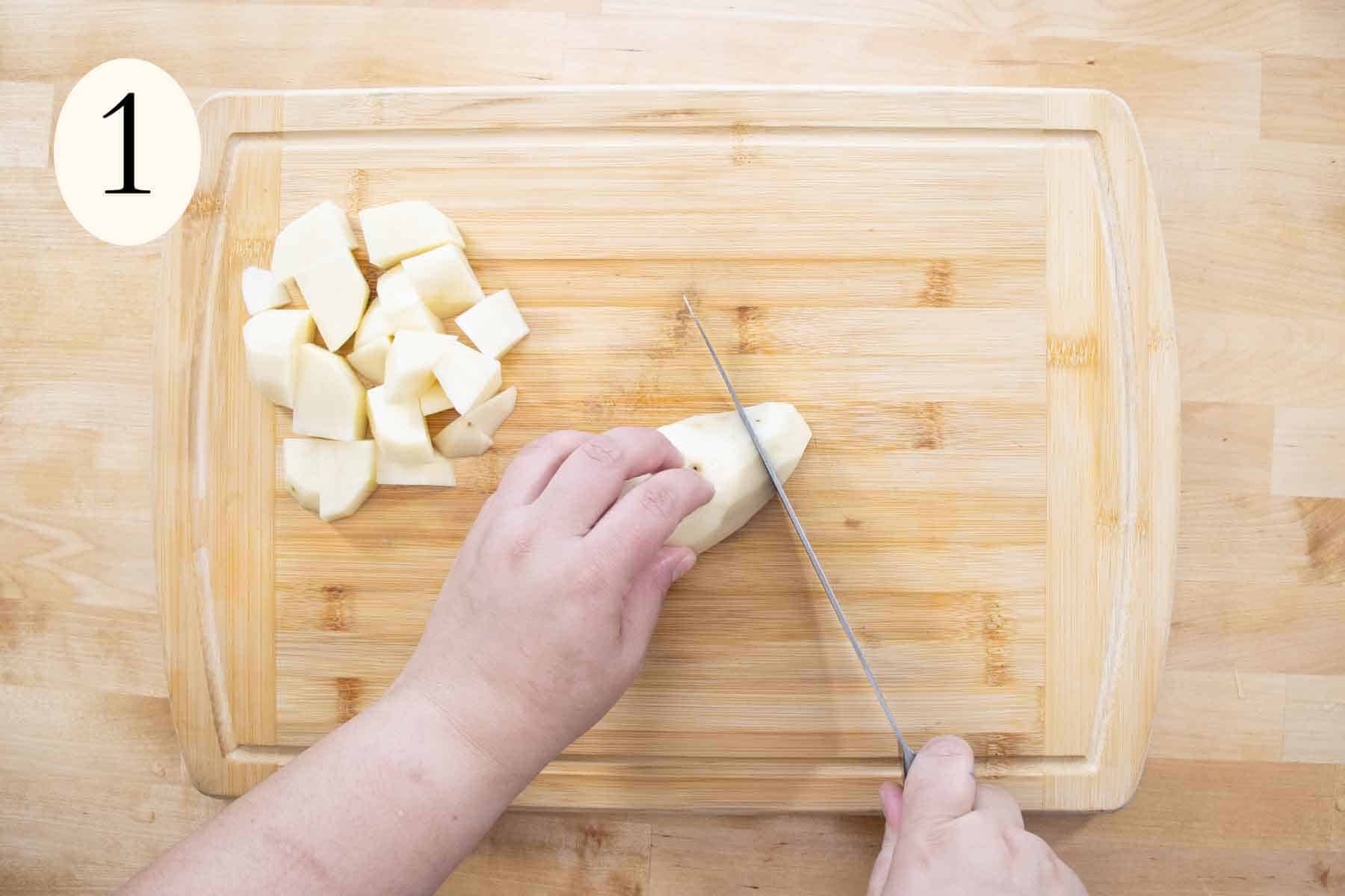 hands cutting a potato.