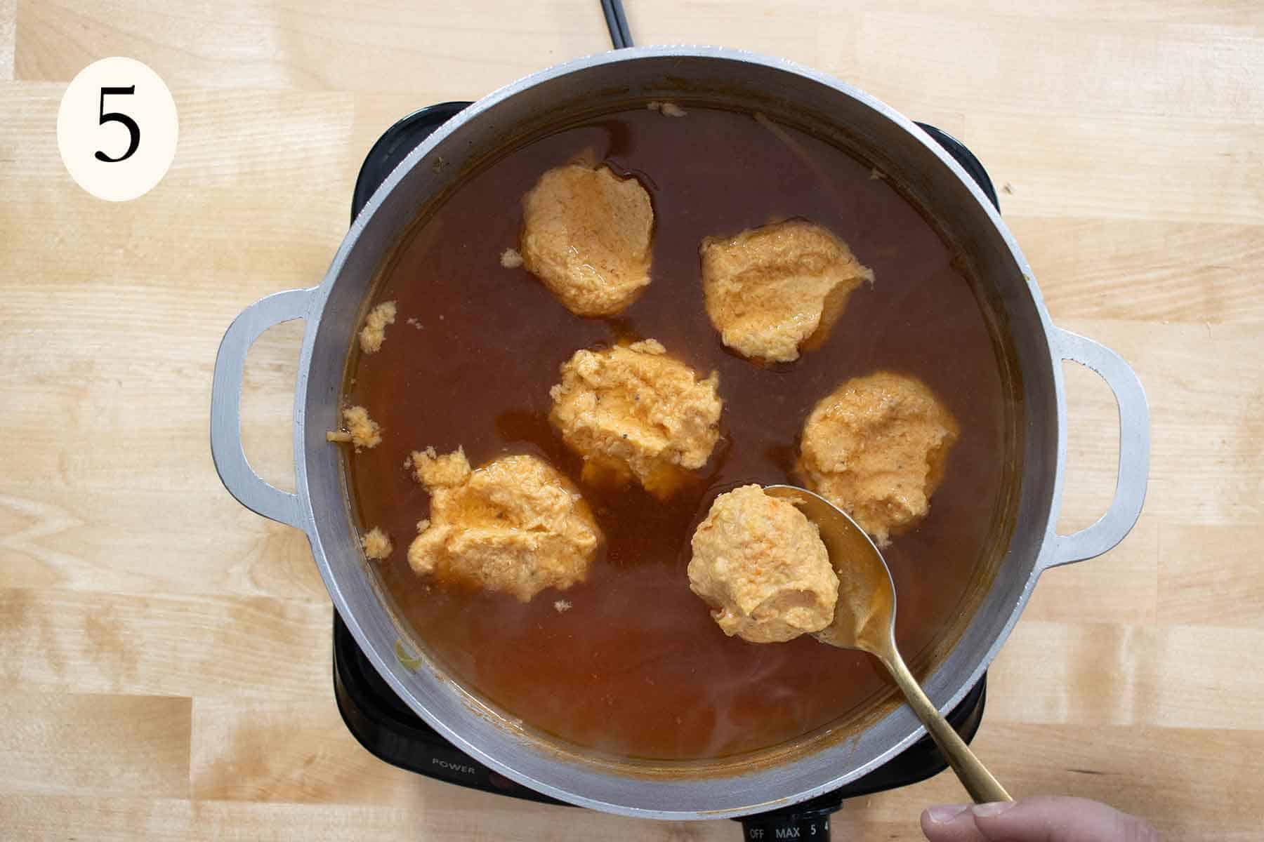bolitas de platano being cooked in a soup.