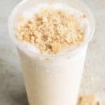 a limber de cheesecake on a table with graham cracker crumbs around.