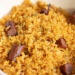 a plate full of puerto rican arroz con salchichas.