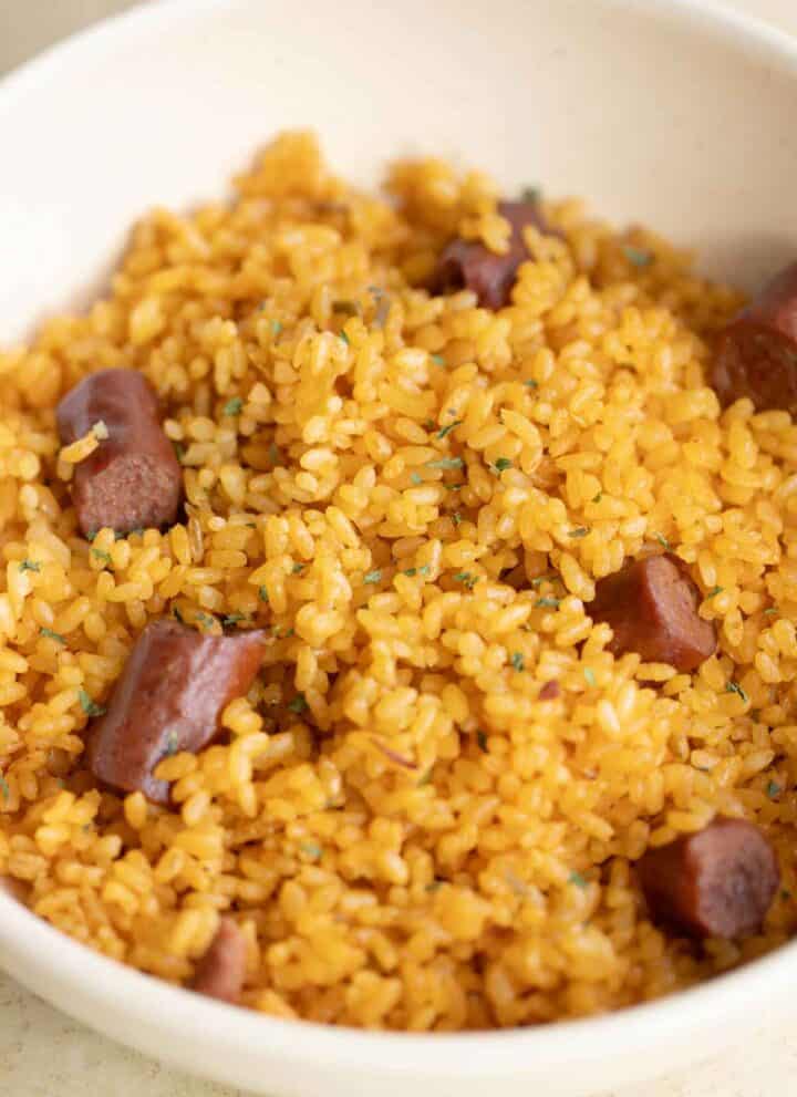 a plate full of puerto rican arroz con salchichas.