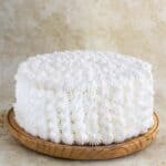 a puerto rican cake or bizcocho mojadito on a plate with a white buttercream.