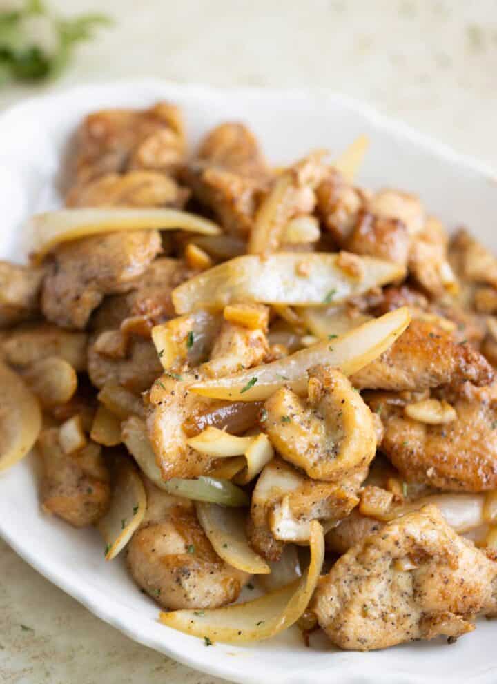 a plate full of a Puerto Rican garlic butter chicken also known as a pollo al ajillo.