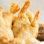 a plate with a few crispy fried shrimp in a take out style.