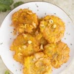 a plate with puerto rican style tostones al ajillo with some parsley on the side as garnish.