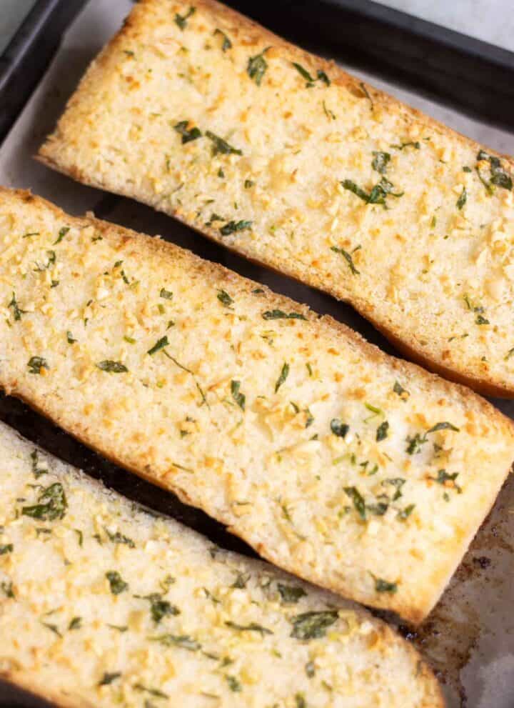 3 half loafs of pan con ajo which is garlic bread made with fresh garlic.