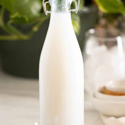 A bottle of homemade coconut syrup used in drinks, cocktails, and desserts.