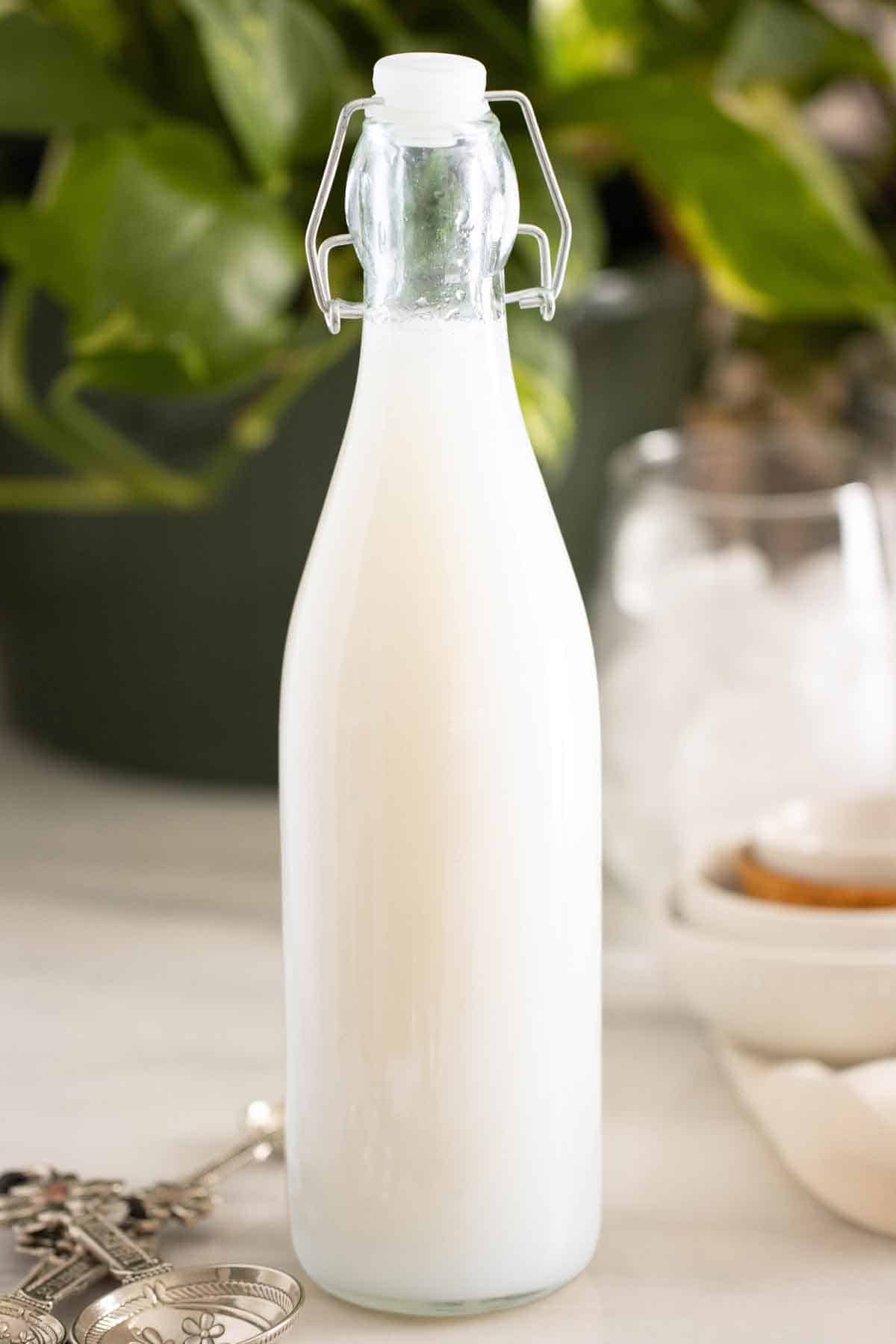 A bottle of homemade coconut syrup used in drinks, cocktails, and desserts.