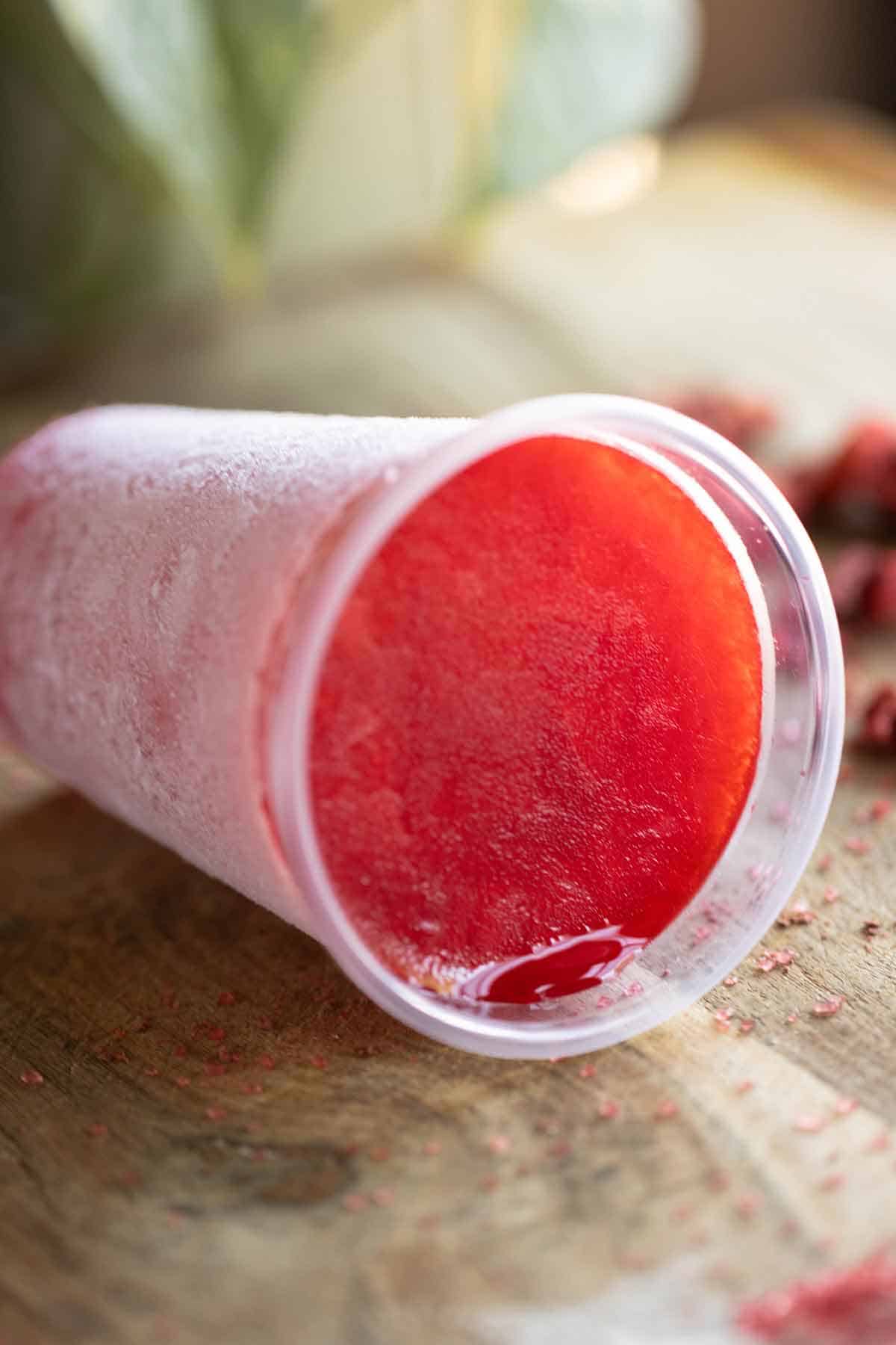 A cup of a strawberry flavor Puerto Rican limber.