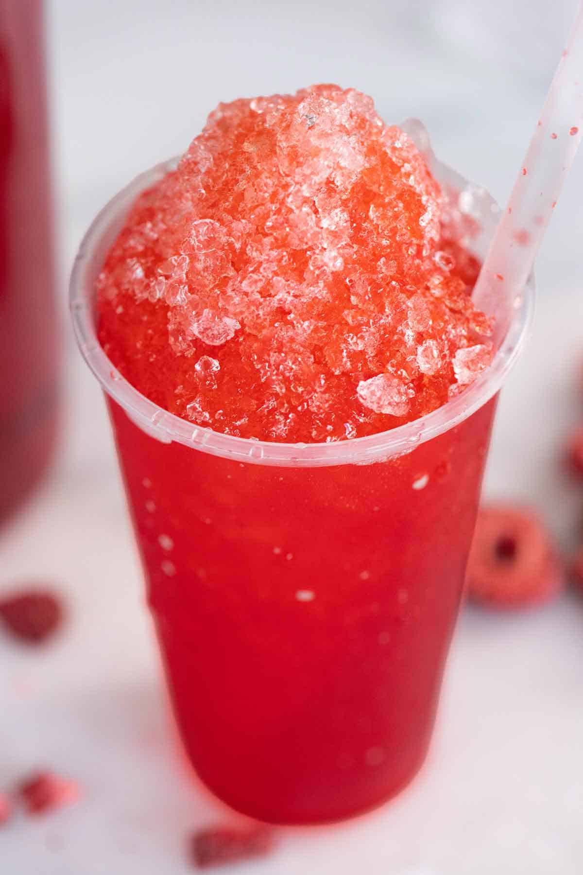 A cup of a Puerto Rican piragua strawberry flavor.