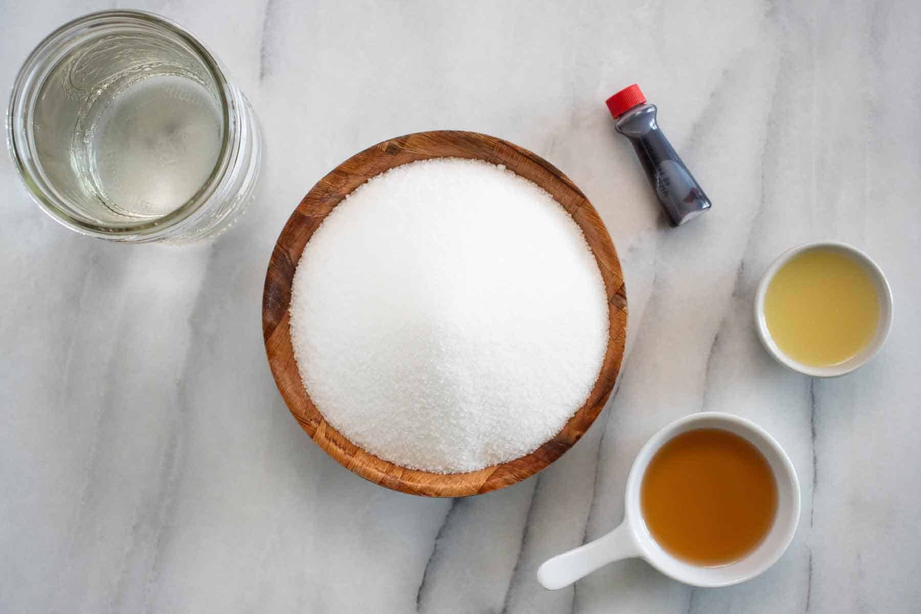 All the ingredients needed to make a homemade strawberry syrup.