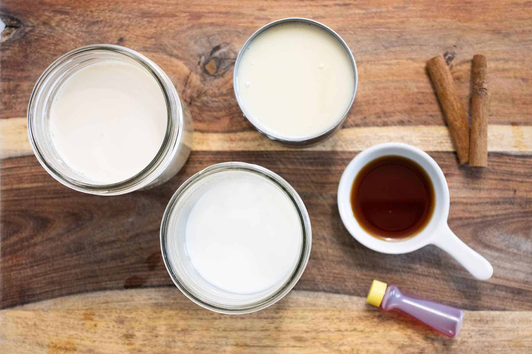 All the ingredients needed to make a homemade vanilla syrup with different types of milks.
