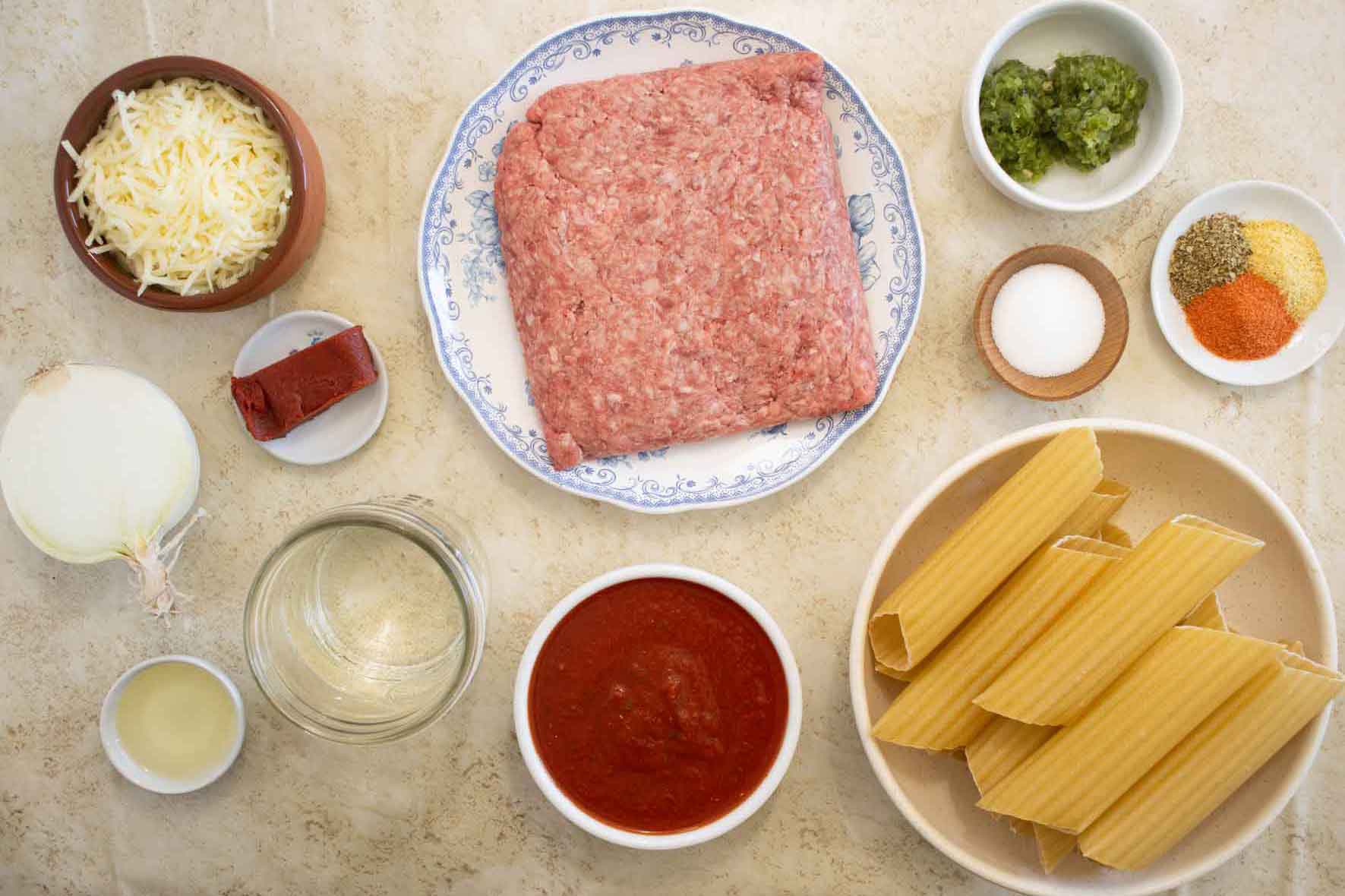All the ingredients needed to make beef stuffed cannelloni in a puerto rican style.