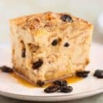 A square piece of a bread pudding with raisins and caramel.