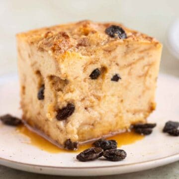 A square piece of a bread pudding with raisins and caramel.