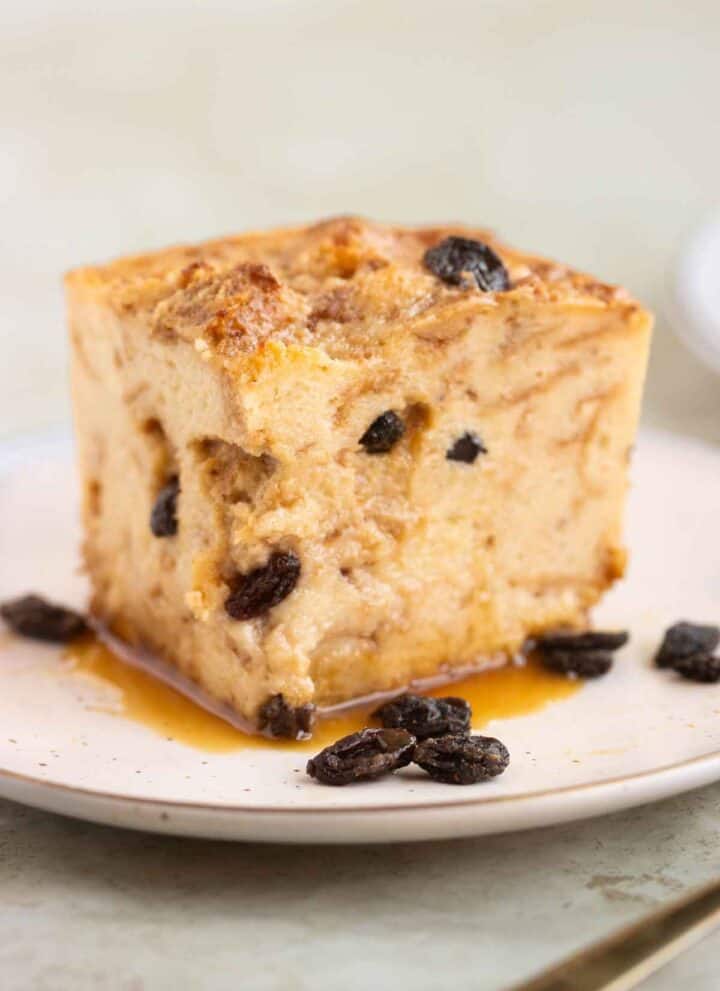 A square piece of a bread pudding with raisins and caramel.