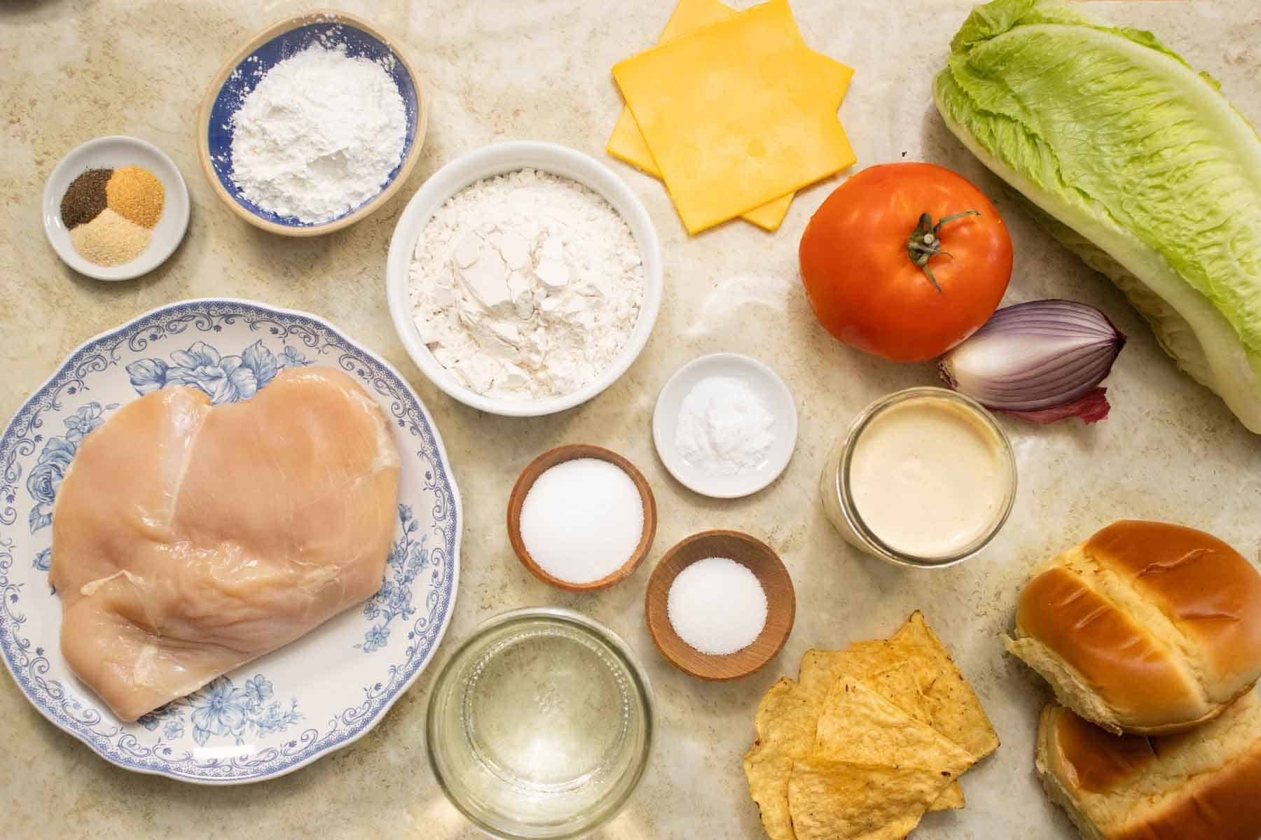 All the ingredients needed to make a fried chicken sandwich.