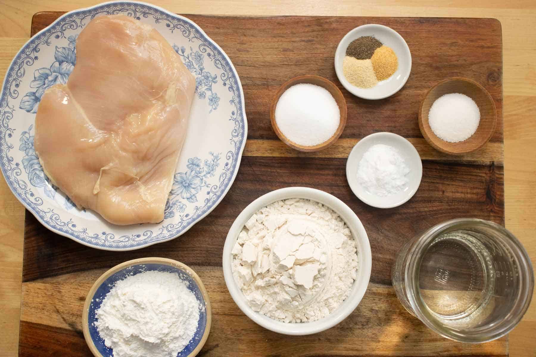 All the ingredients needed to make a crispy fried chicken breast.